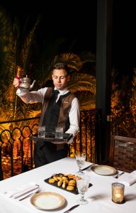 Butler pouring drinks after partridge shooting